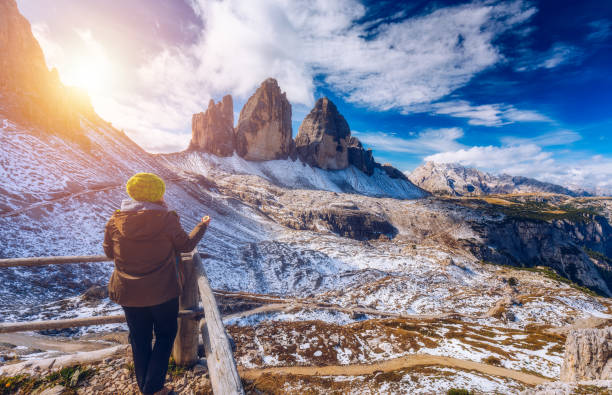istock Women hand using a compass in the mountains, travel concept. Hand with compass at mountain road, background of mountains in summer, point of view. 960177782