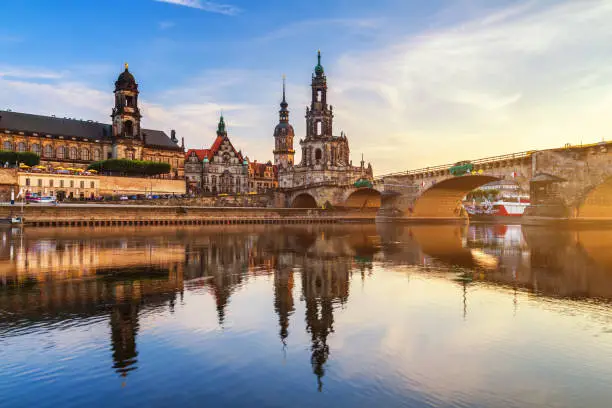 Photo of Augustus Bridge (Augustusbrucke) and Cathedral of the Holy Trinity (Hofkirche) over the River Elbe in Dresden, Germany, Saxony.