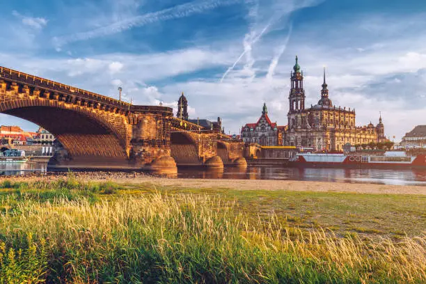 Photo of Augustus Bridge (Augustusbrucke) and Cathedral of the Holy Trinity (Hofkirche) over the River Elbe in Dresden, Germany, Saxony.