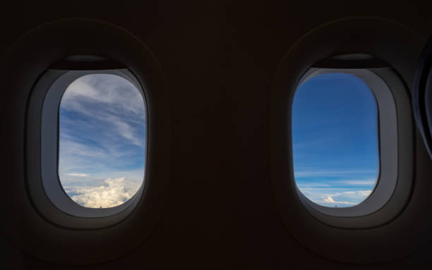 istock Airplane window, cloudscape seen through an airplane window from the passenger seat. 960180932