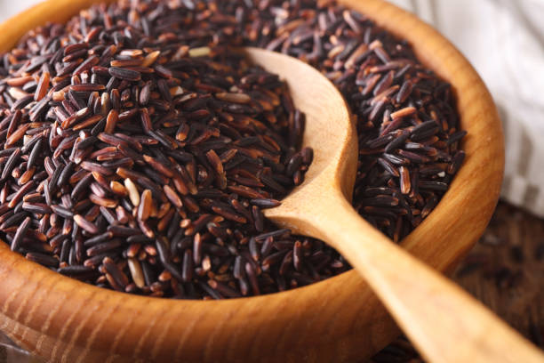 istock Raw wild black rice in a bowl macro. Horizontal 960181664