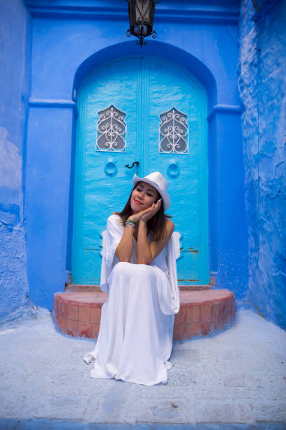 istock Chinese woman happily visiting Chefchaouen, Morocco 960184734