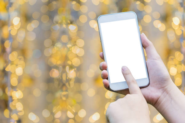 istock woman hand holding,using and touch smart phone,cell phone,mobile over blurred image of  bokeh background 960185676