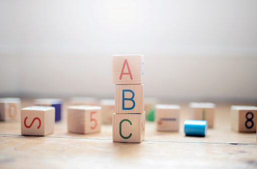 Toy building blocks stacked to spell out ABC