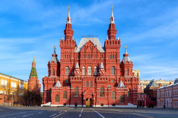 nidentified tourists at red square near History Museum in morning time Moscow, Russia-April 10,2018:Unidentified tourists at red square near History Museum in morning time.The State Historical Museum is a museum of Russian history wedged between Red Square and Manege Square in Moscow red square stock pictures, royalty-free photos & images