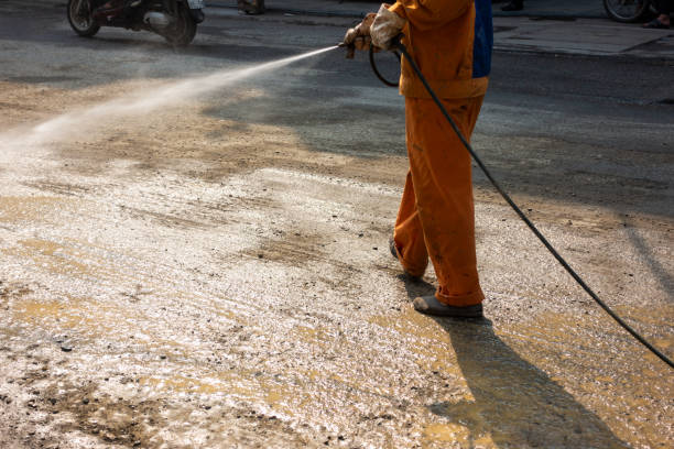istock Worker making street wet with water spray at construction area 960190922