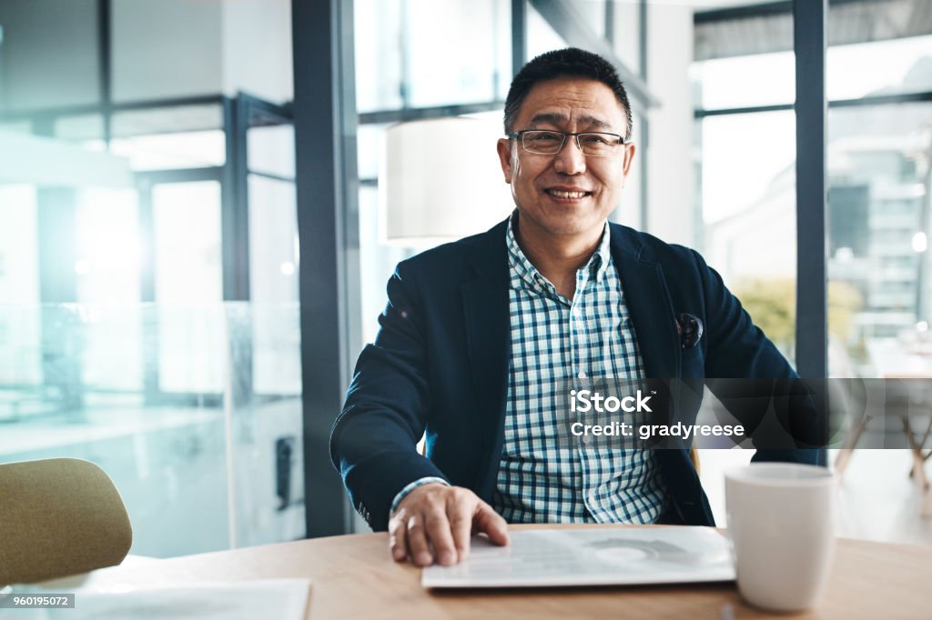 I always bring success to my name Portrait of a mature businessman working in an office Asian and Indian Ethnicities Stock Photo