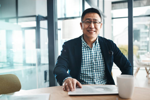 I always bring success to my name Portrait of a mature businessman working in an office korean ethnicity photos stock pictures, royalty-free photos & images