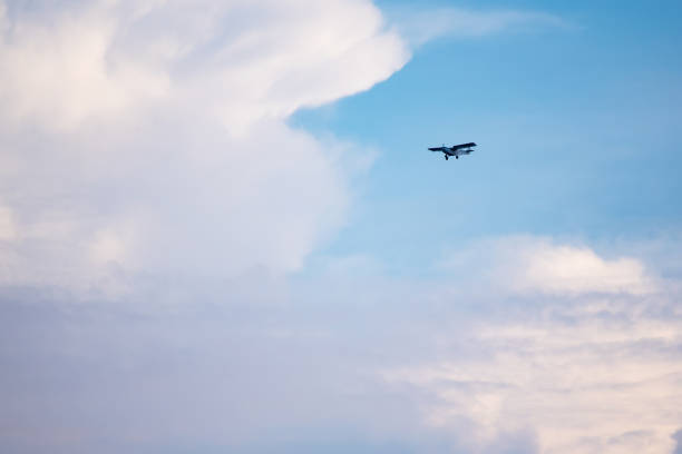 istock Small plane in the air. Blue sky with white clouds. 960195652