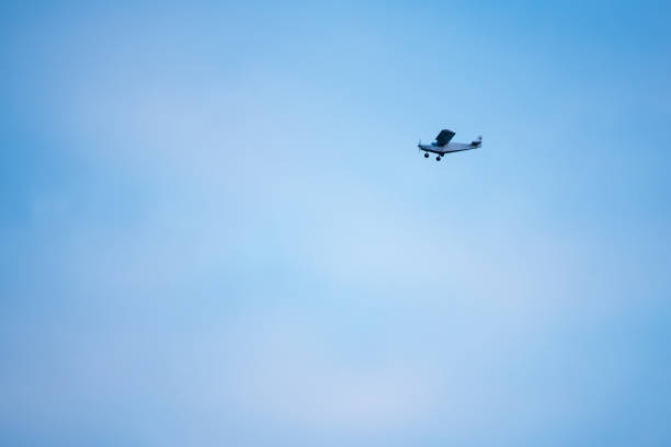 istock Small plane in the air. Blue sky with white clouds. 960195698