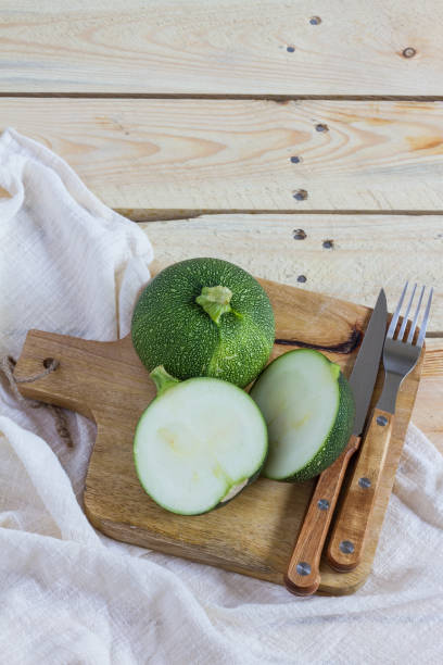 istock Green zucchini balls. Wooden table and board. 960196490