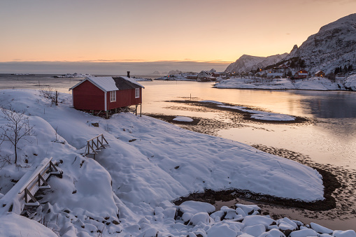 Wooden tourist cabin, rorbu, on nordic winter coast near Tind and Sorvagen, Lofoten, Norway with beautiful sea view