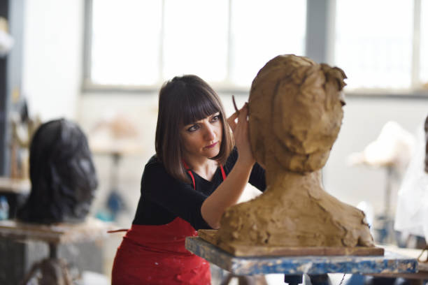 istock Young Female Sculptor is working in her studio 960207836