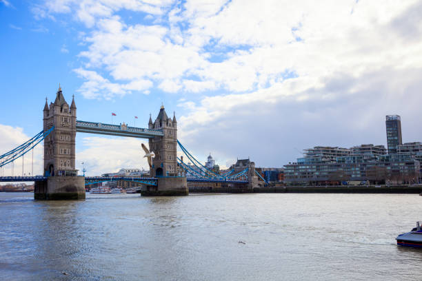 Tower Bridge, one of the London's most famous landmarks, is a bascule and suspension bridge on River Thames. It has two towers, in Victorian Gothic style, that are connected with two walkways that are constructed so they can resist horizontal forces from suspended parts of the bridge. 2018
