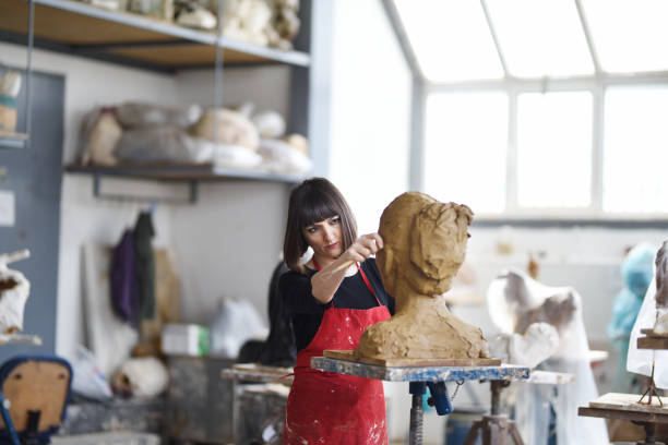 istock Young Female Sculptor is working in her studio 960208774