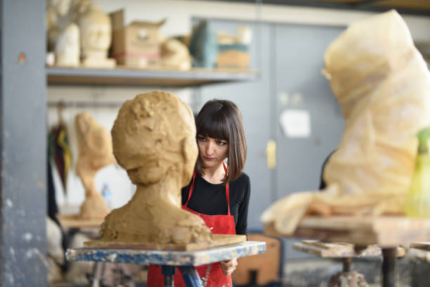 istock Young Female Sculptor is working in her studio 960208914