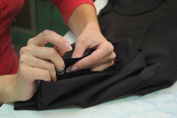 istock Tailor's business. The hem of the pants manually with a needle and thread 960209214