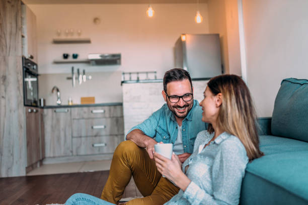 istock Smiling couple having tea and talking at home. 960209436