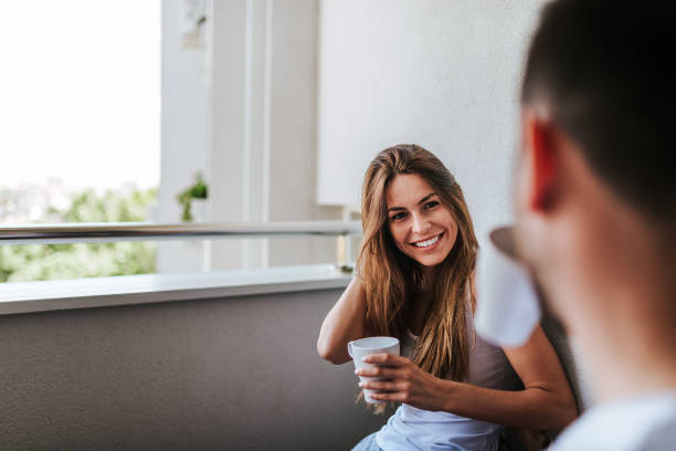 istock Young couple drinking morning coffee on the balcony. 960209580