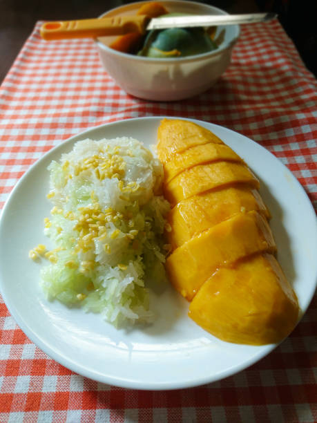 istock Mango with Sticky Rice, Thai dessert on orange checkered tablecloth background 960213460