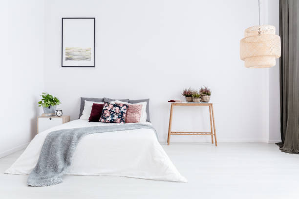 istock White bedroom with floral cushion 960214040