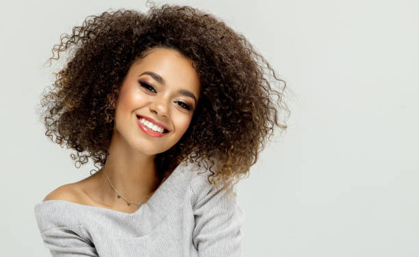 istock Beautiful smiling black woman sitting on studio background 960216844