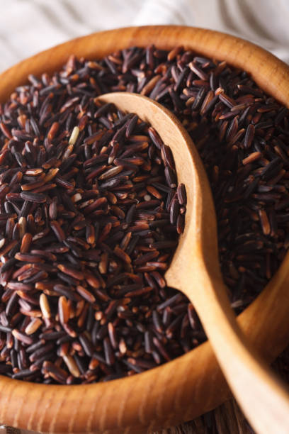 istock Raw wild black rice in a bowl macro. Vertical 960218732