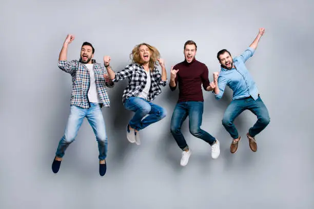 Leadership network leisure rest relax recreation enjoy vacation stag party people concept. Four dreamy funky delightful screaming football fans gesturing jumping up isolated on gray background