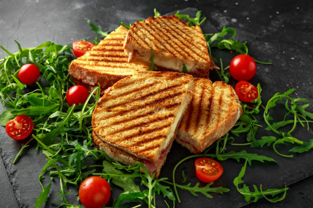 istock Grilled Bacon, cheese sandwich and served on stone platter with arugula and tomatoes 960221968