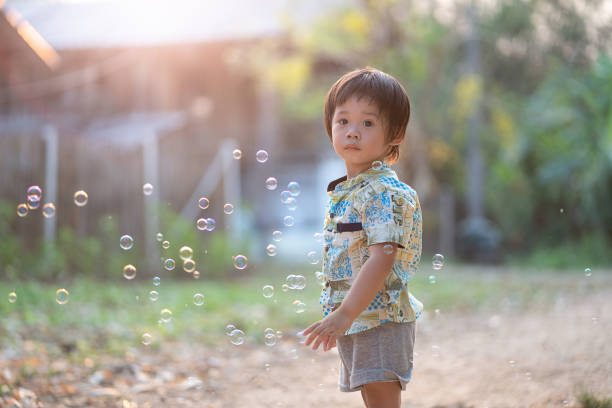 istock Asean boy standing to look bubble 960222112