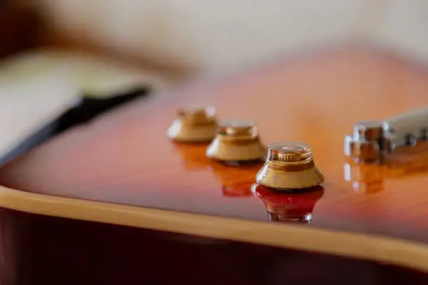 Photo of Electric guitar body and neck detail on wooden background vintage look