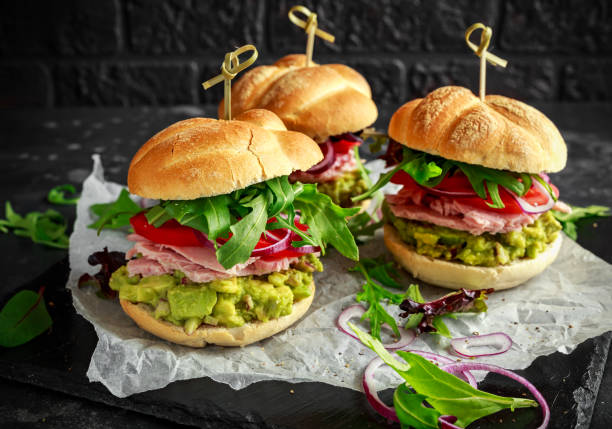 istock Fresh home sandwich with avocado guacamole, tomatoes, arugula, red onion and ham 960226234