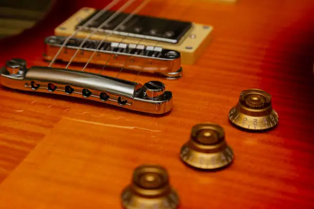 Photo of Electric guitar body and neck detail on wooden background vintage look