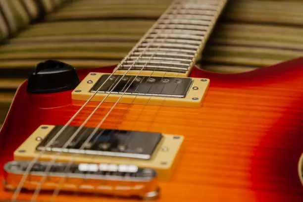 Photo of Electric guitar body and neck detail on wooden background vintage look