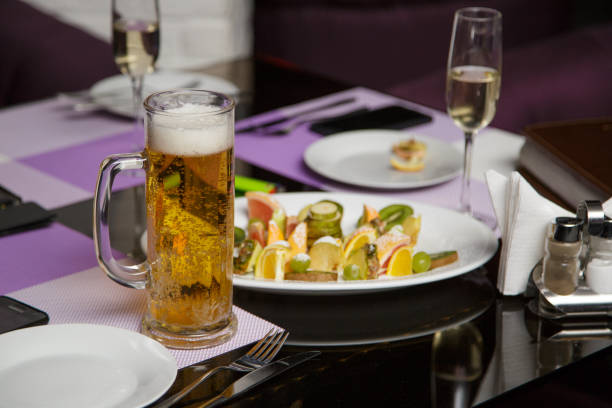 istock Mug of beer on a glass table with a snack 960231920