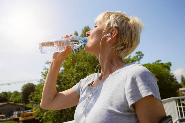 istock Mature woman is hydrating after run 960239602
