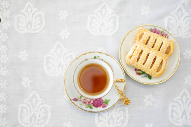 Top view of vintage and classic style tea cup place on the white table clothe with apple tart