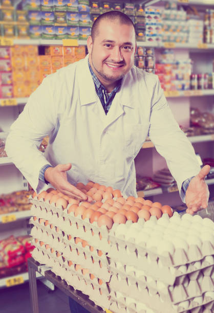 istock Seller posing with dozens of eggs 960245376