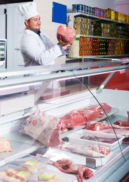istock Butcher cutting fresh lamb meat 960245424