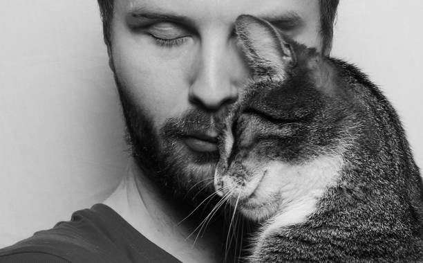 istock Close-Up Of Young Man With Cat By Wall 960248696
