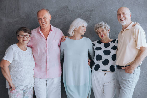 istock Smiling senior people having fun against concrete wall 960248718