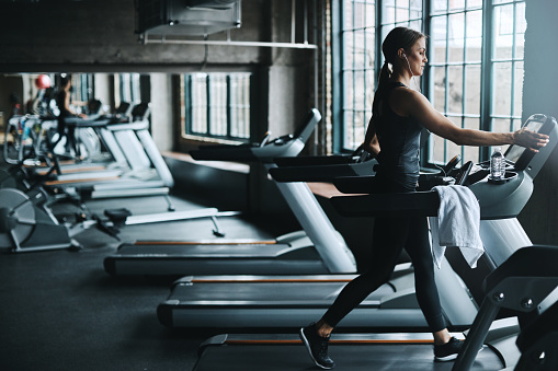 Shot of an attractive young woman working out on a treadmill in a gym