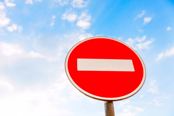 istock road sign entry prohibited. against a blue sky with clouds 960249634