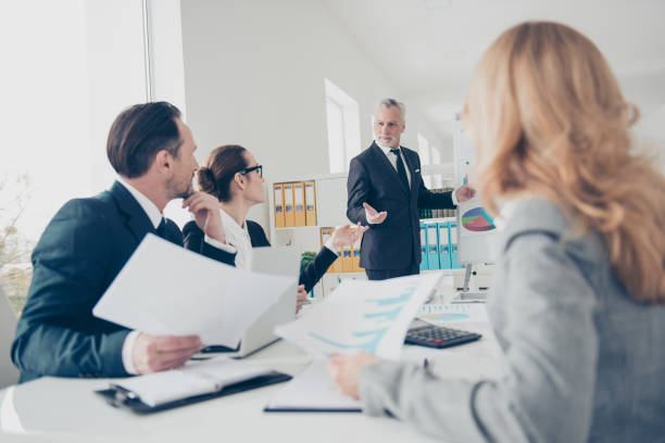 istock Handsome, attractive, stylish senior in suit with tie and serious expression making presentation to his colleague, discussing plan, strategy, listen ideas, thoughts, gesture with hands 960254920
