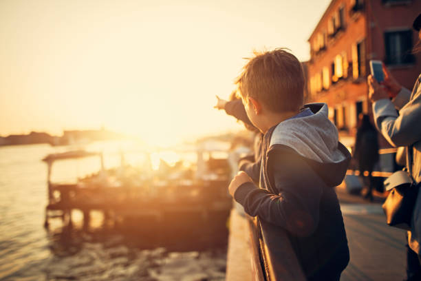 A boy looks at the sea