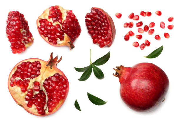 istock pomegranate fruit with seeds and green leaves isolated on white background top view 960259242