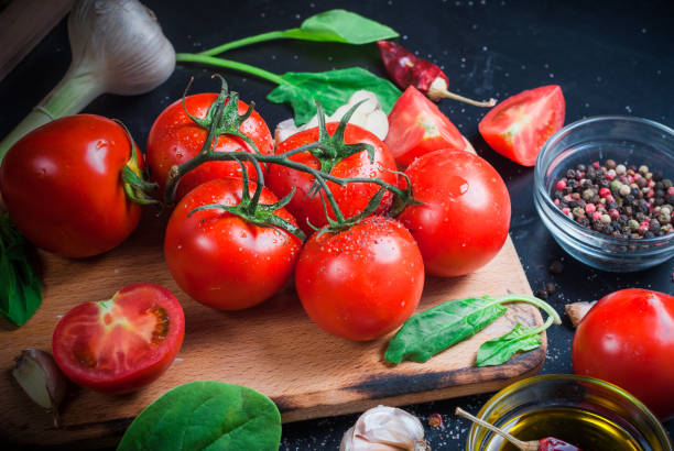 istock cherry tomatoes on a branch, oil,  parsley and spice 960259884