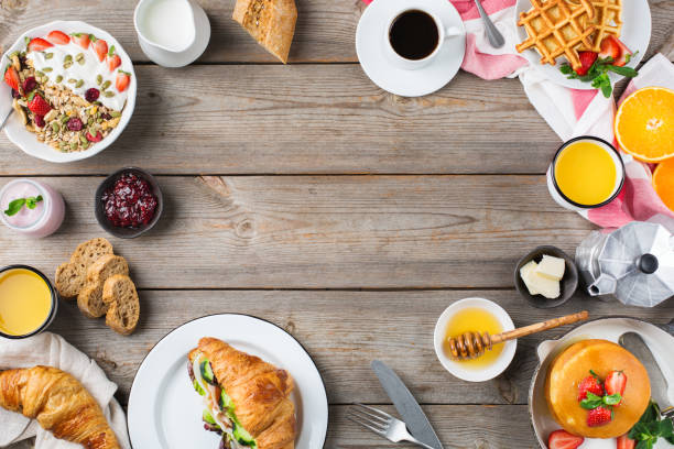 istock Breakfast table with waffles, granola, yogurt, pancakes, juice, coffee 960268654