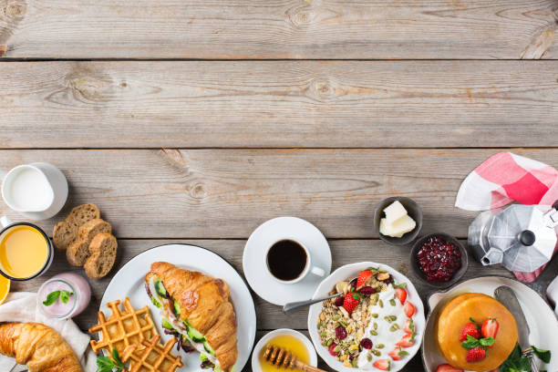 istock Breakfast table with waffles, granola, yogurt, pancakes, juice, coffee 960268760