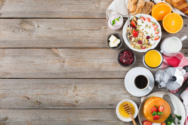 istock Breakfast table with waffles, granola, yogurt, pancakes, juice, coffee 960268840